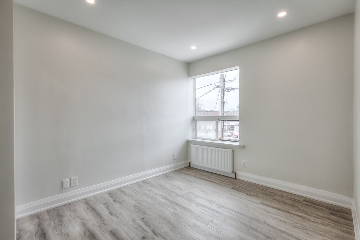 white room with hardwood floor and bright window