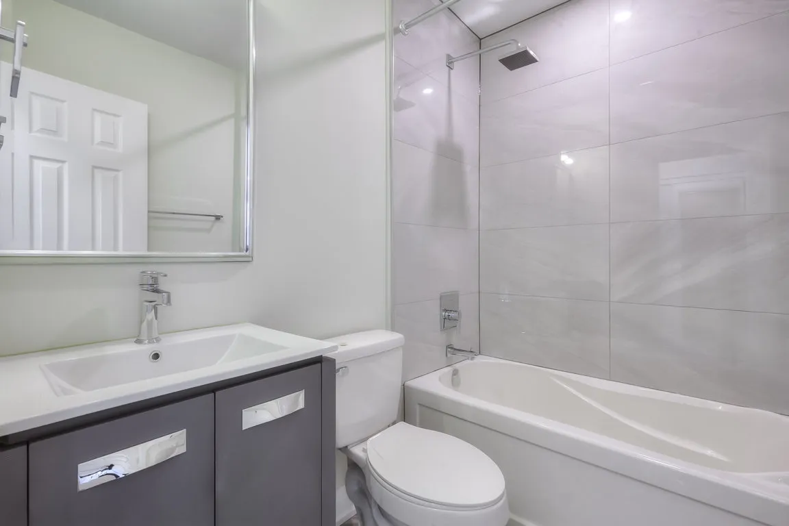 bathroom vanity, toilette and tub