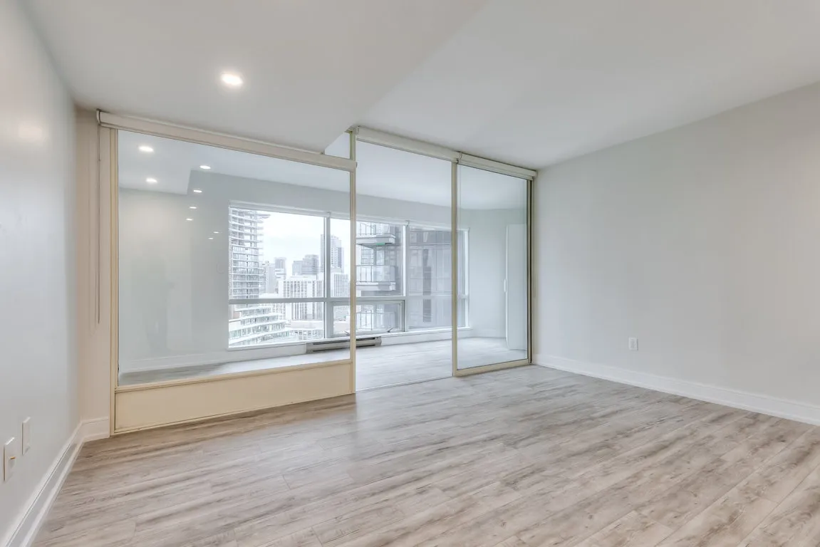 living room looking at sun room with glass sliding doors