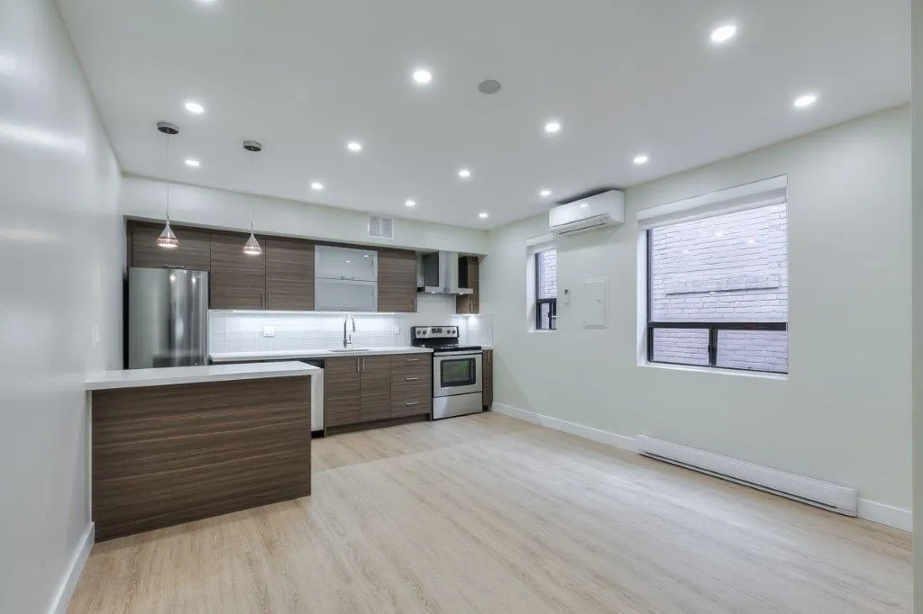 open concept kitch with stainless steal appliances and breakfast bar