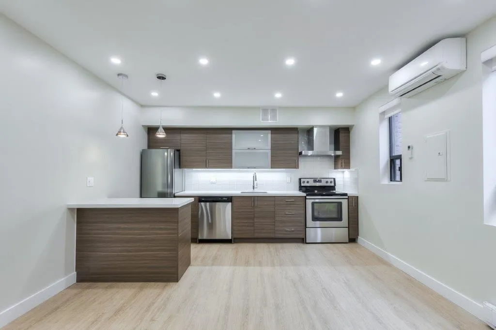 open concept kitch with stainless steal appliances and breakfast bar