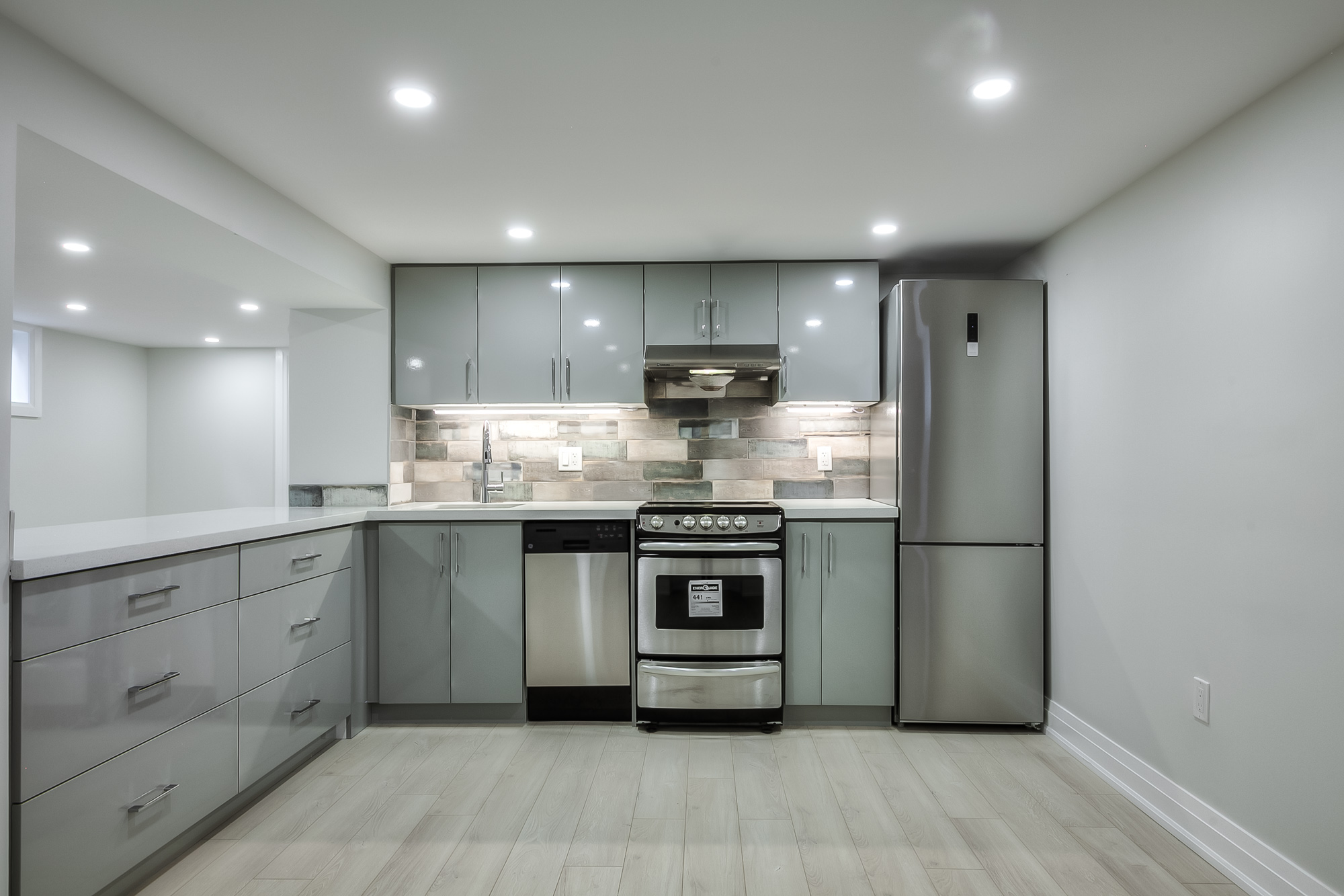 kitchen with white cupboards and counters and stainless steel appliances