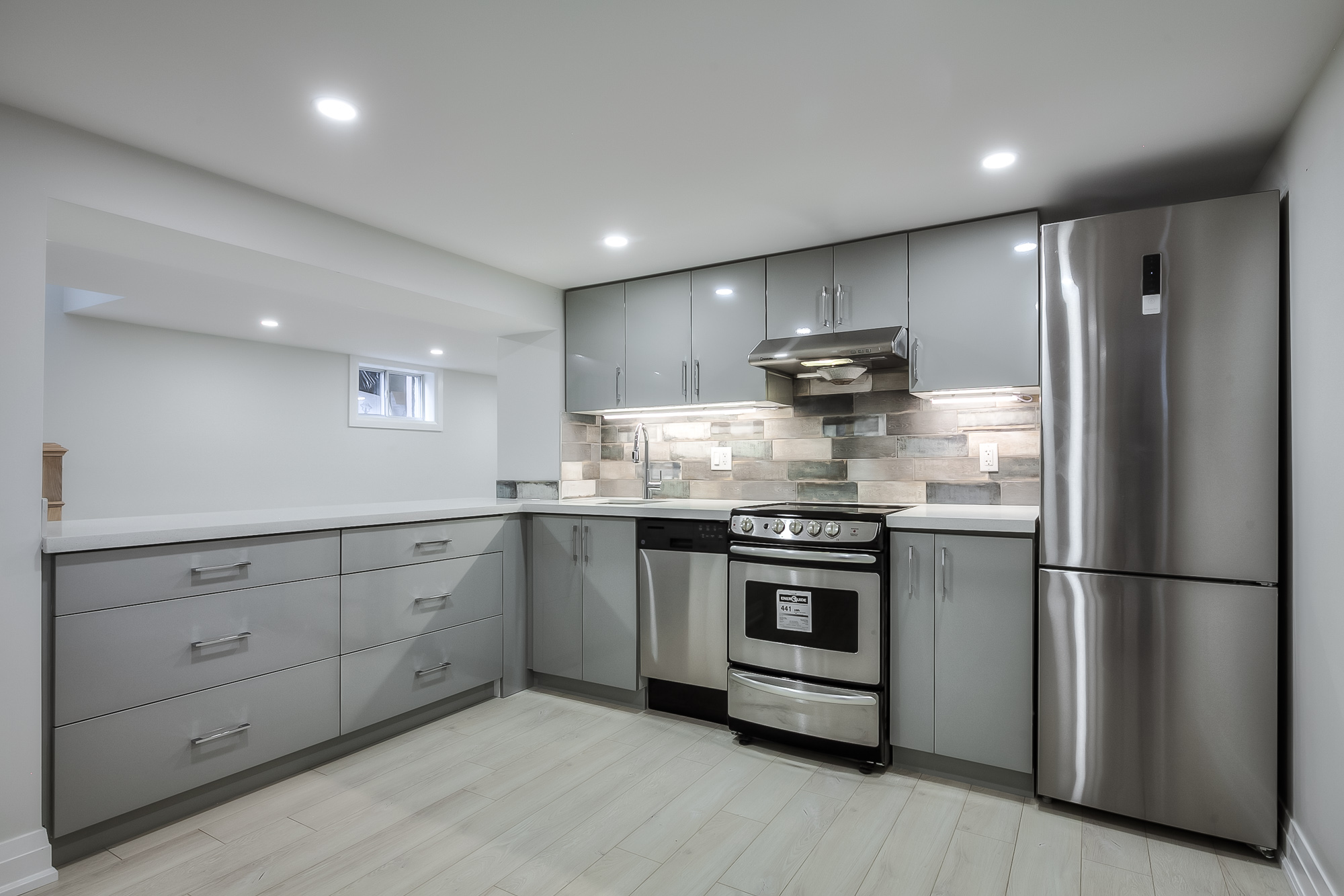 kitchen with white cupboards and counters and stainless steel appliances