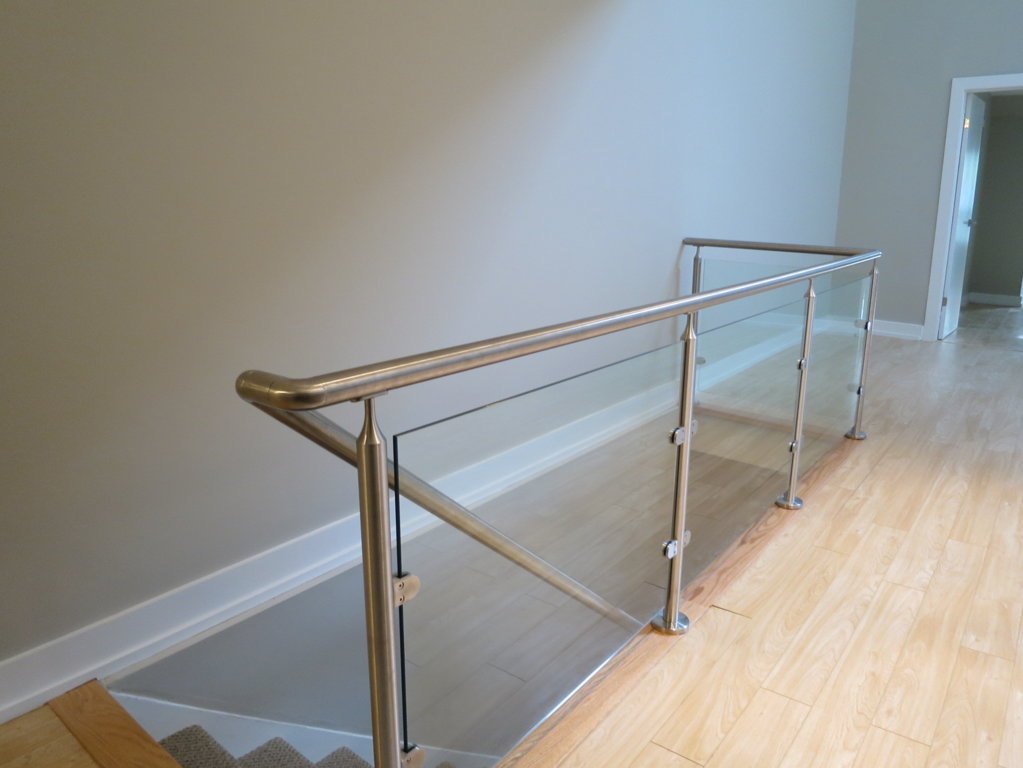 glass wall railing and stairs leading downstairs