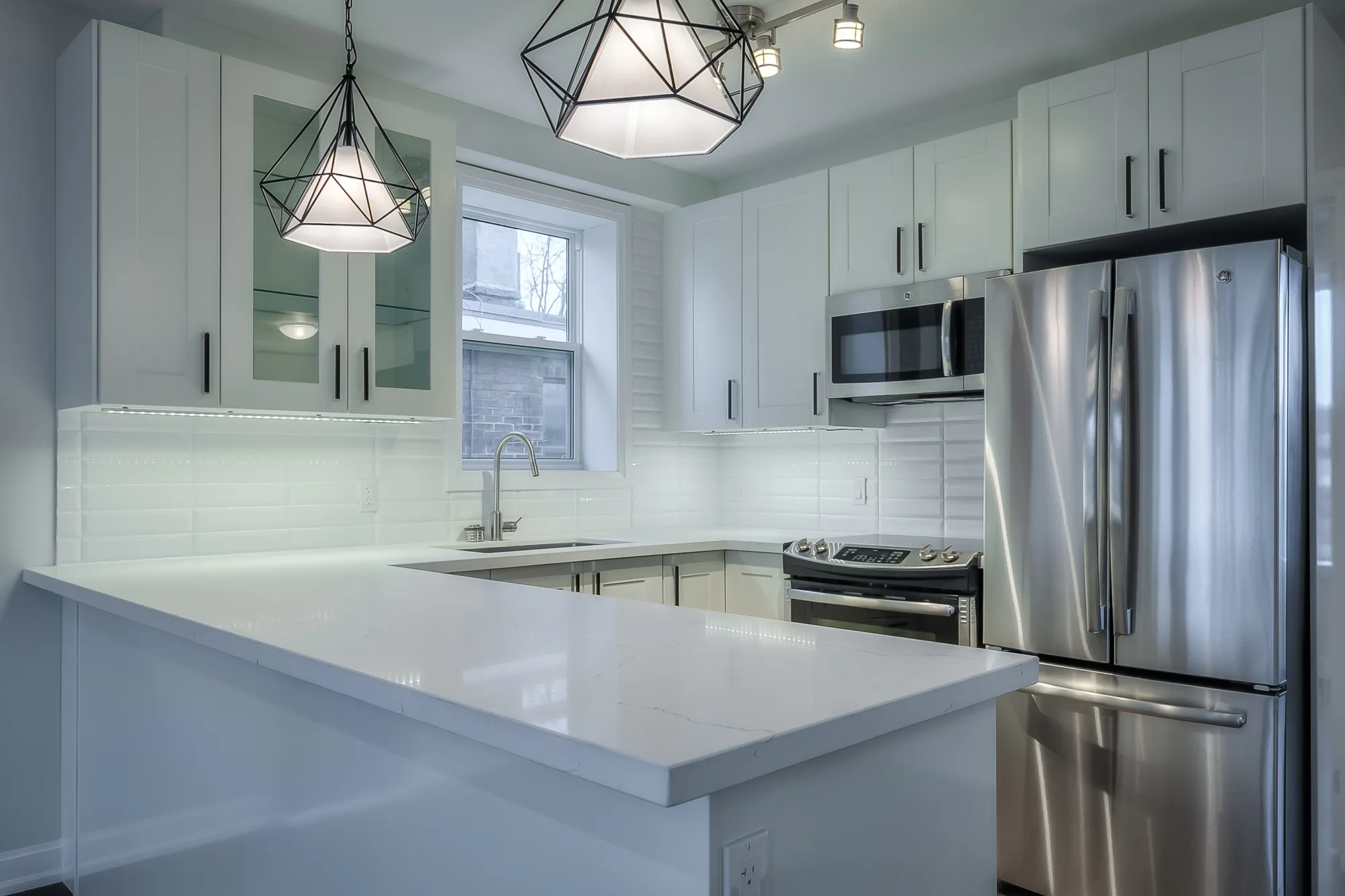 kitchen with white cupboards and counters and stainless steel appliances