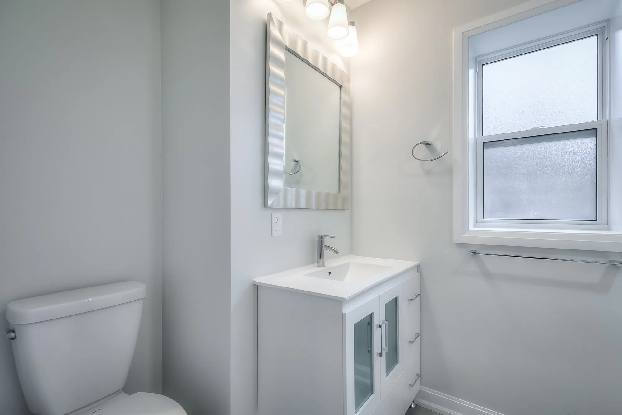 bathroom with vanity and toilette