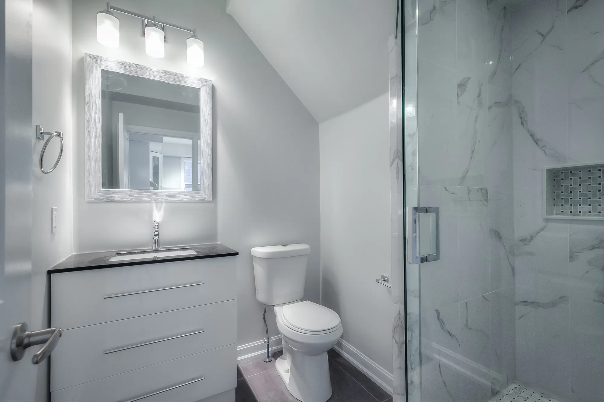 bathroom with vanity, toilette and glass shower