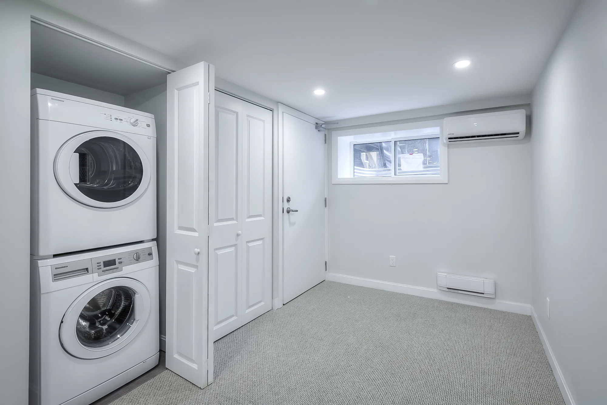 closet with washer and dryer stack