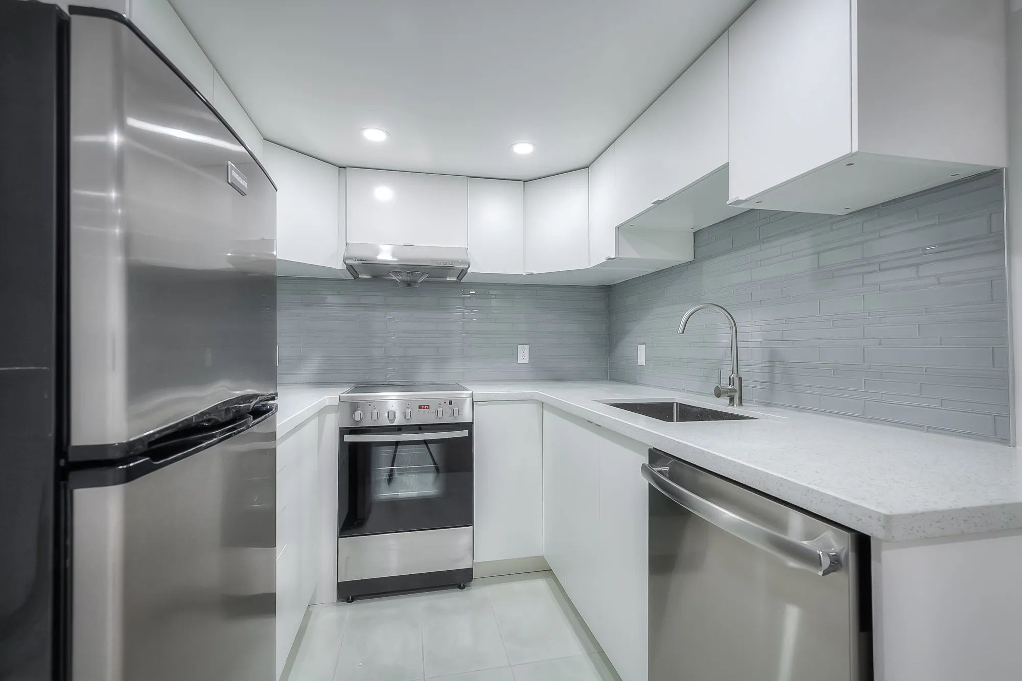 kitchen with white marble counters and stainless steel appliances