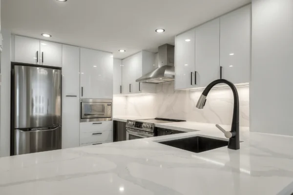 A kitchen with white cabinets and a sink