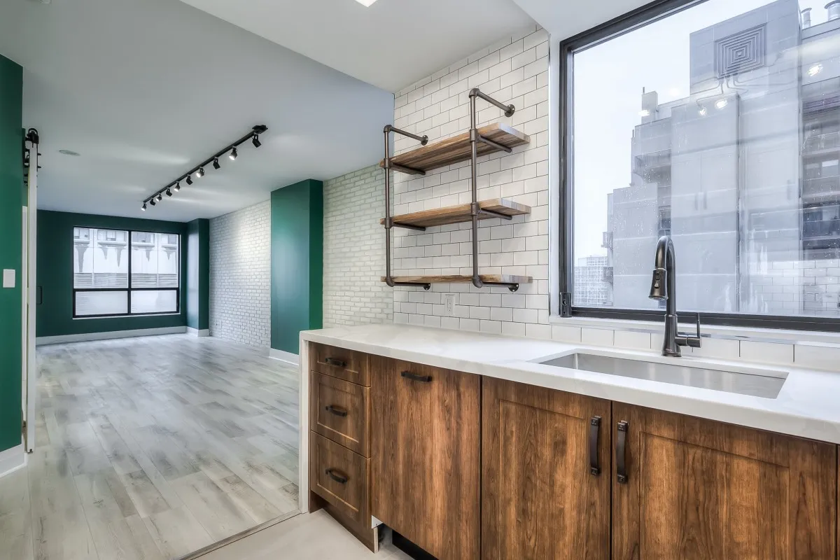 A kitchen with wood cabinets and shelves