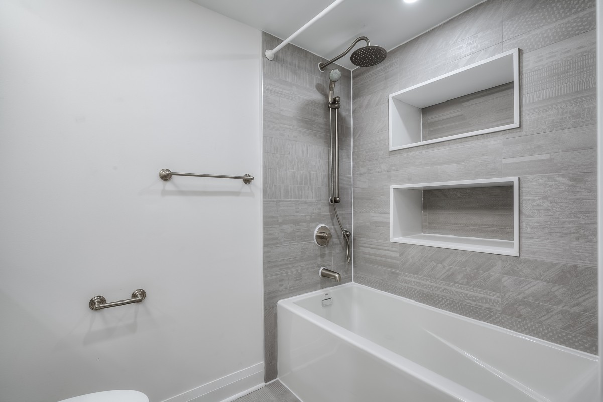 A bathroom with a bathtub shower and a shower head
