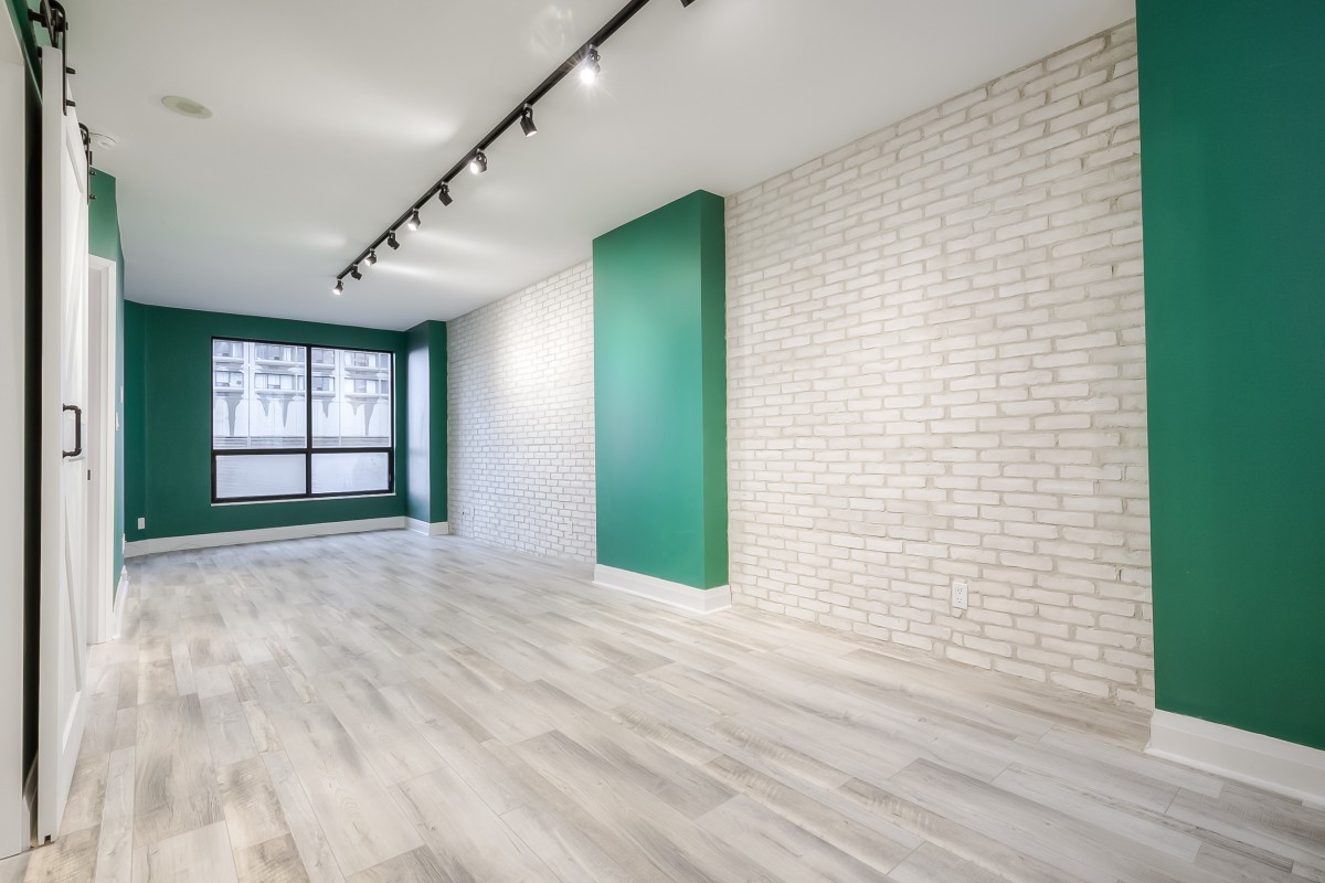 A room with white brick walls and green walls