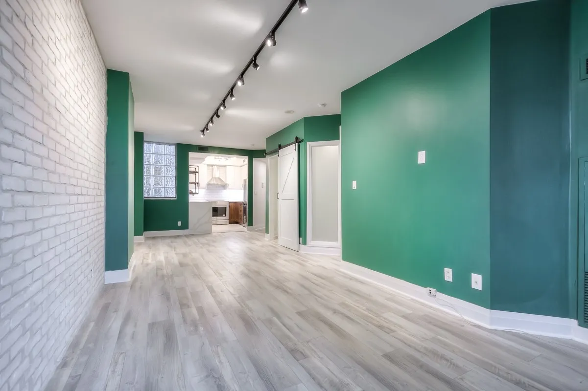 A room with green walls and white brick walls