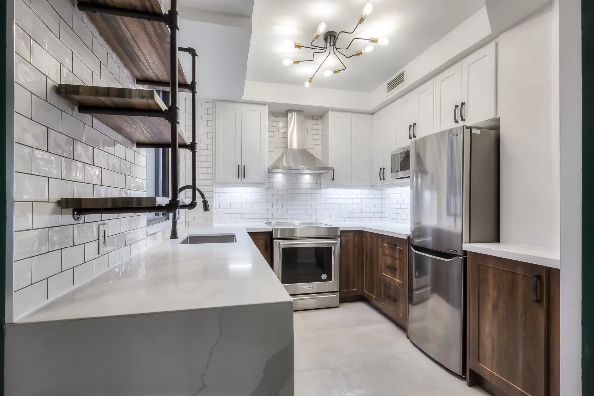 A kitchen with white cabinets and white countertops