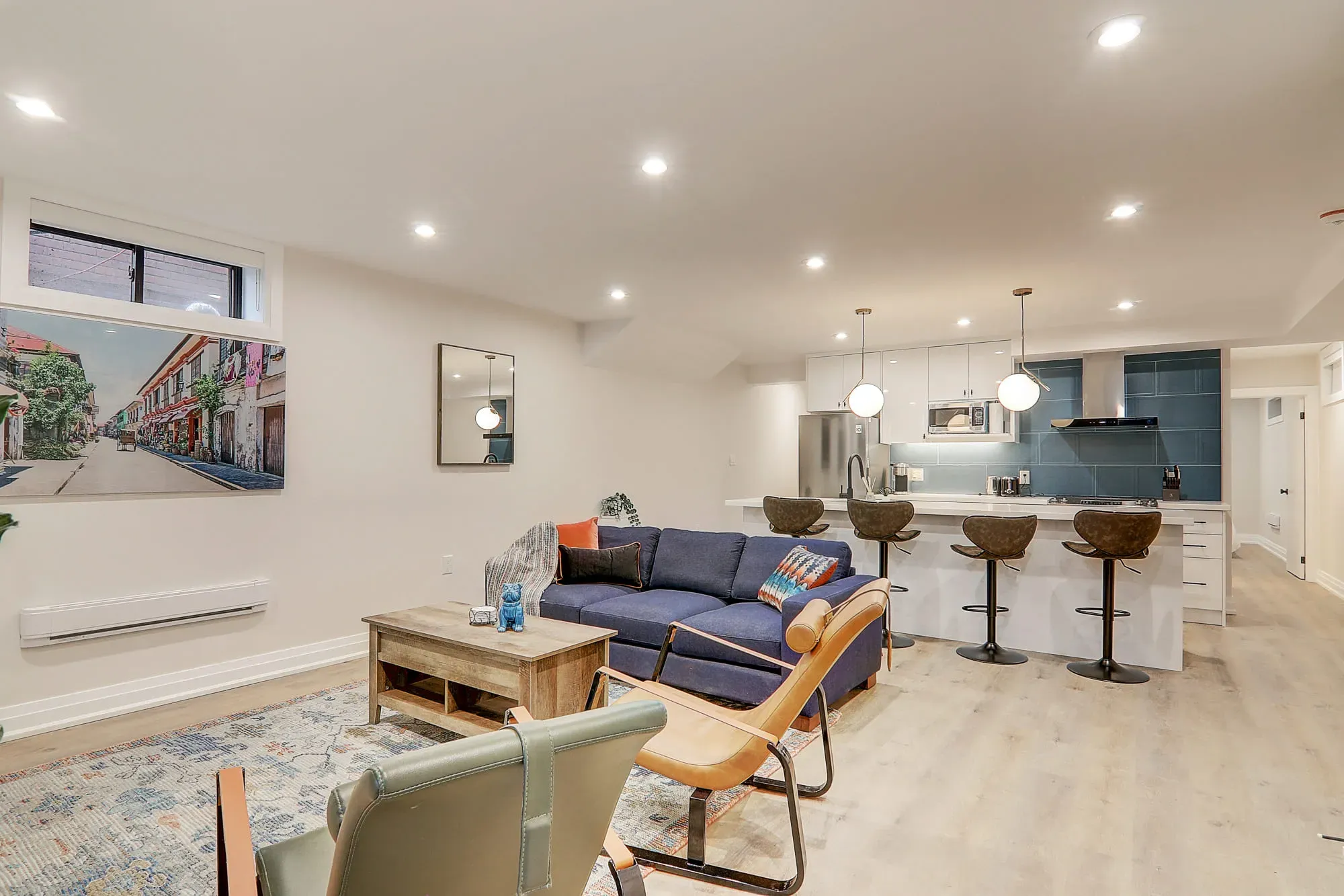 A living room with a couch and kitchen