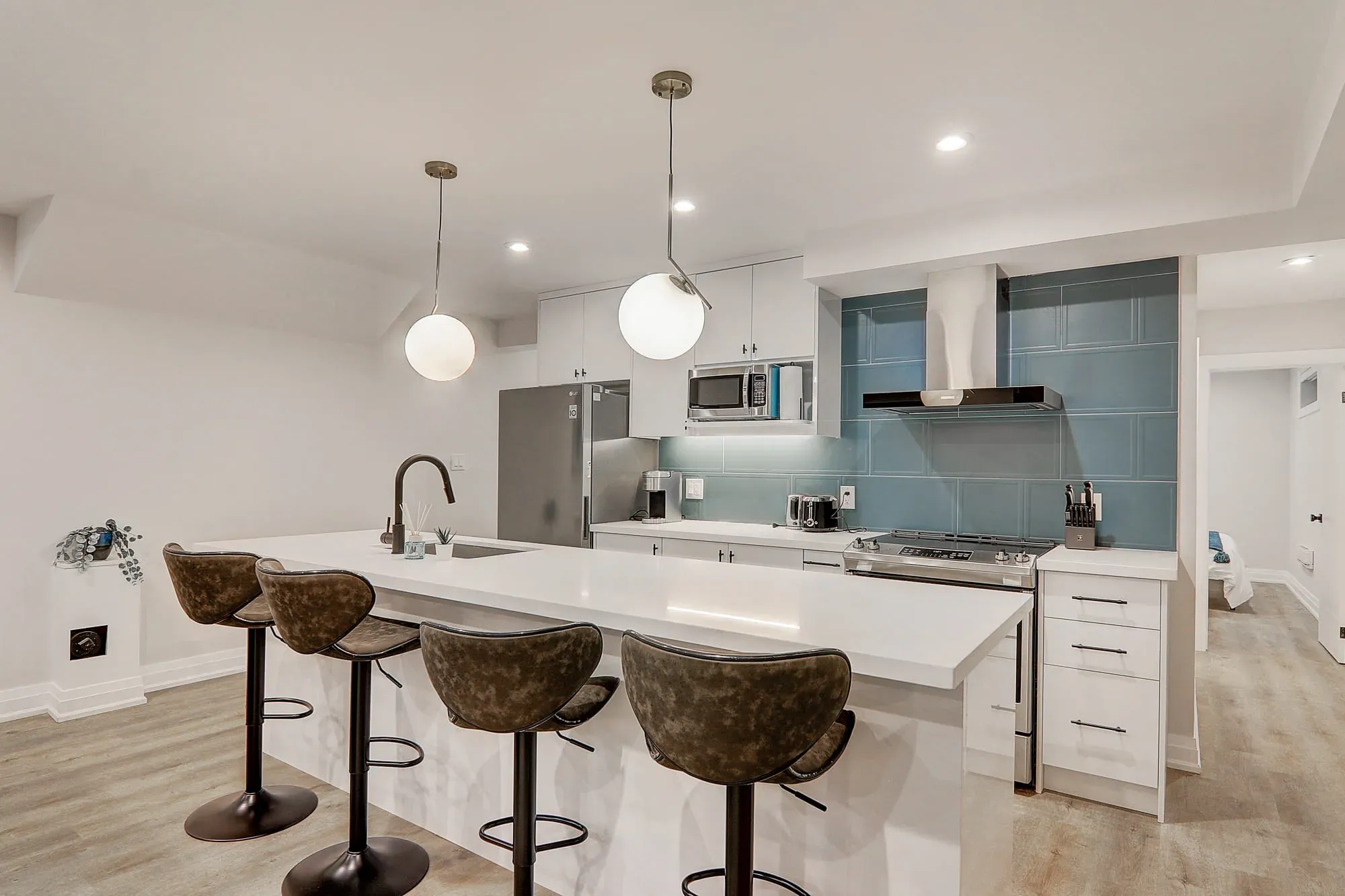 A kitchen with a bar and stools