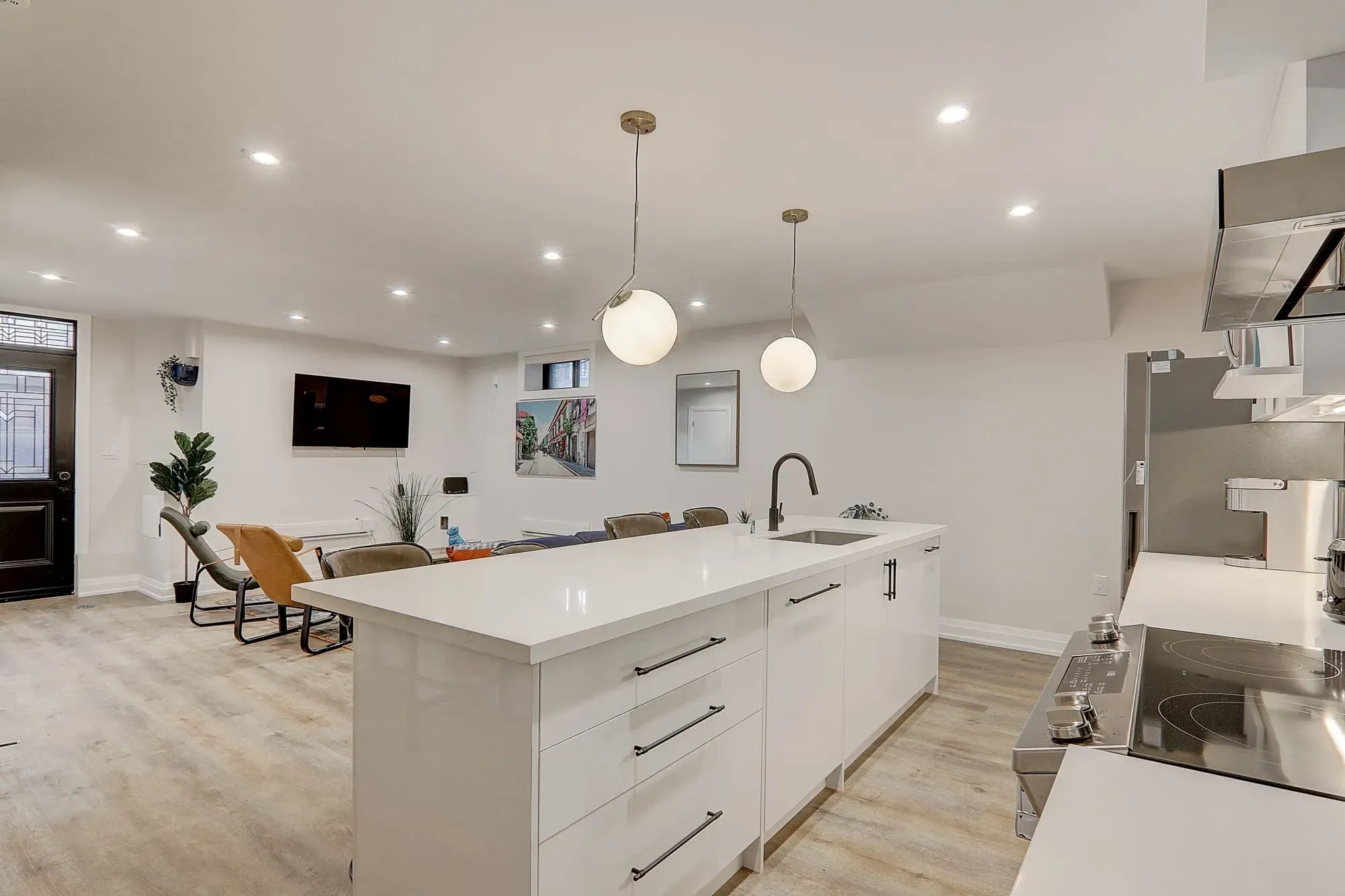 A kitchen with white cabinets and a white countertop