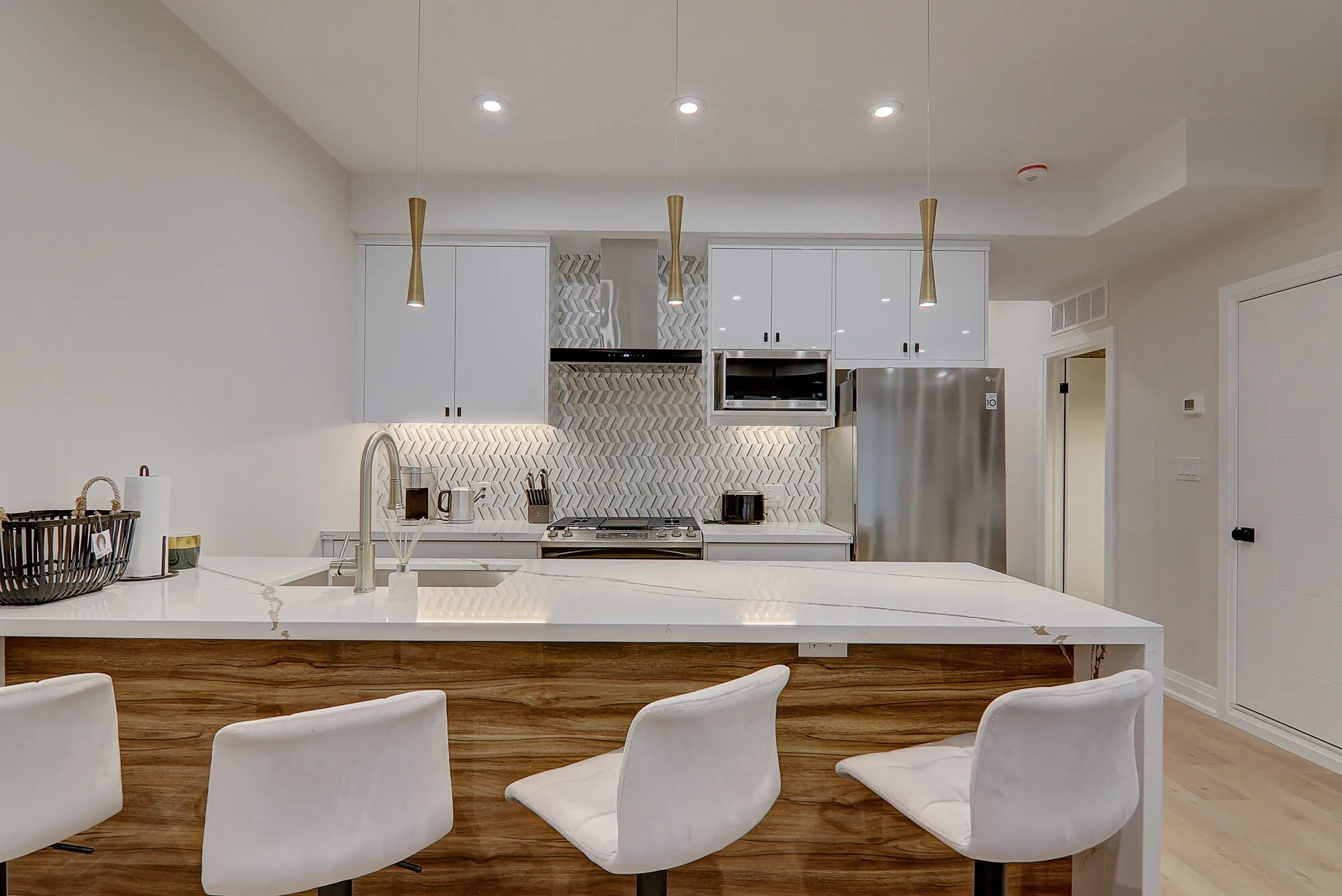 A kitchen with white cabinets and white countertops