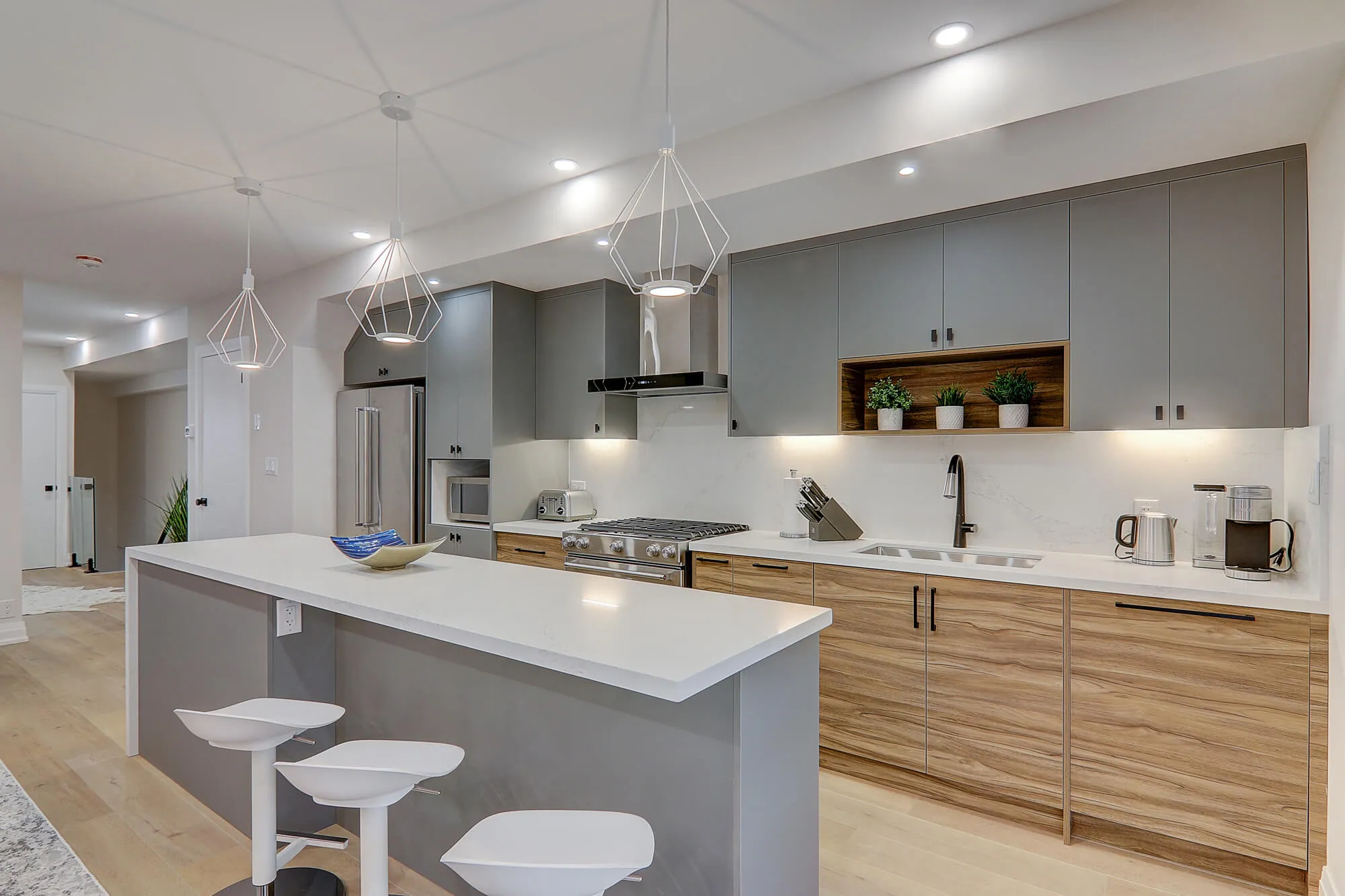 A kitchen with a bar and stools