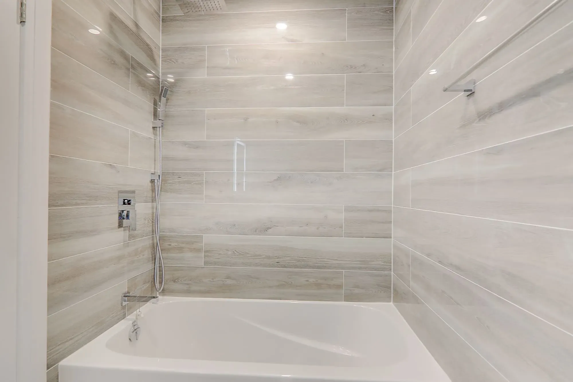 A bathroom with a bathtub and shower