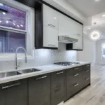 A kitchen with white cabinets and black cabinets