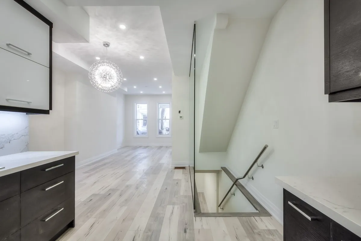 A room with a glass wall and a staircase