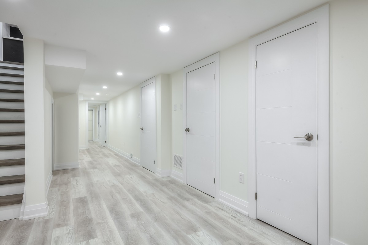 A hallway with white doors
