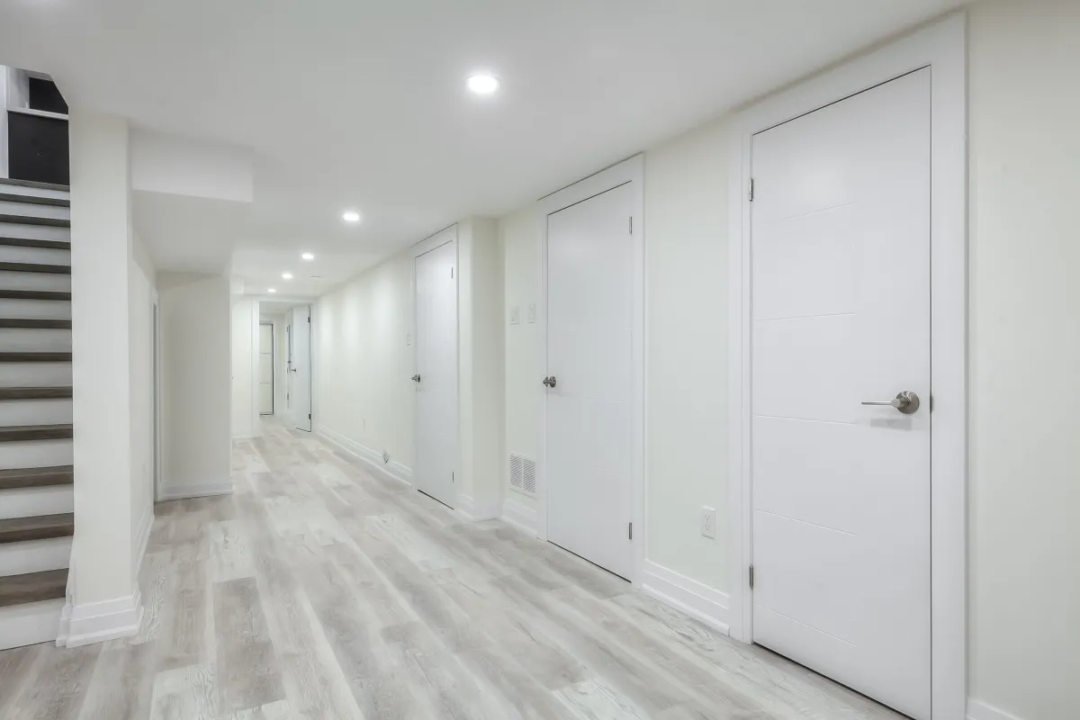 A hallway with white doors