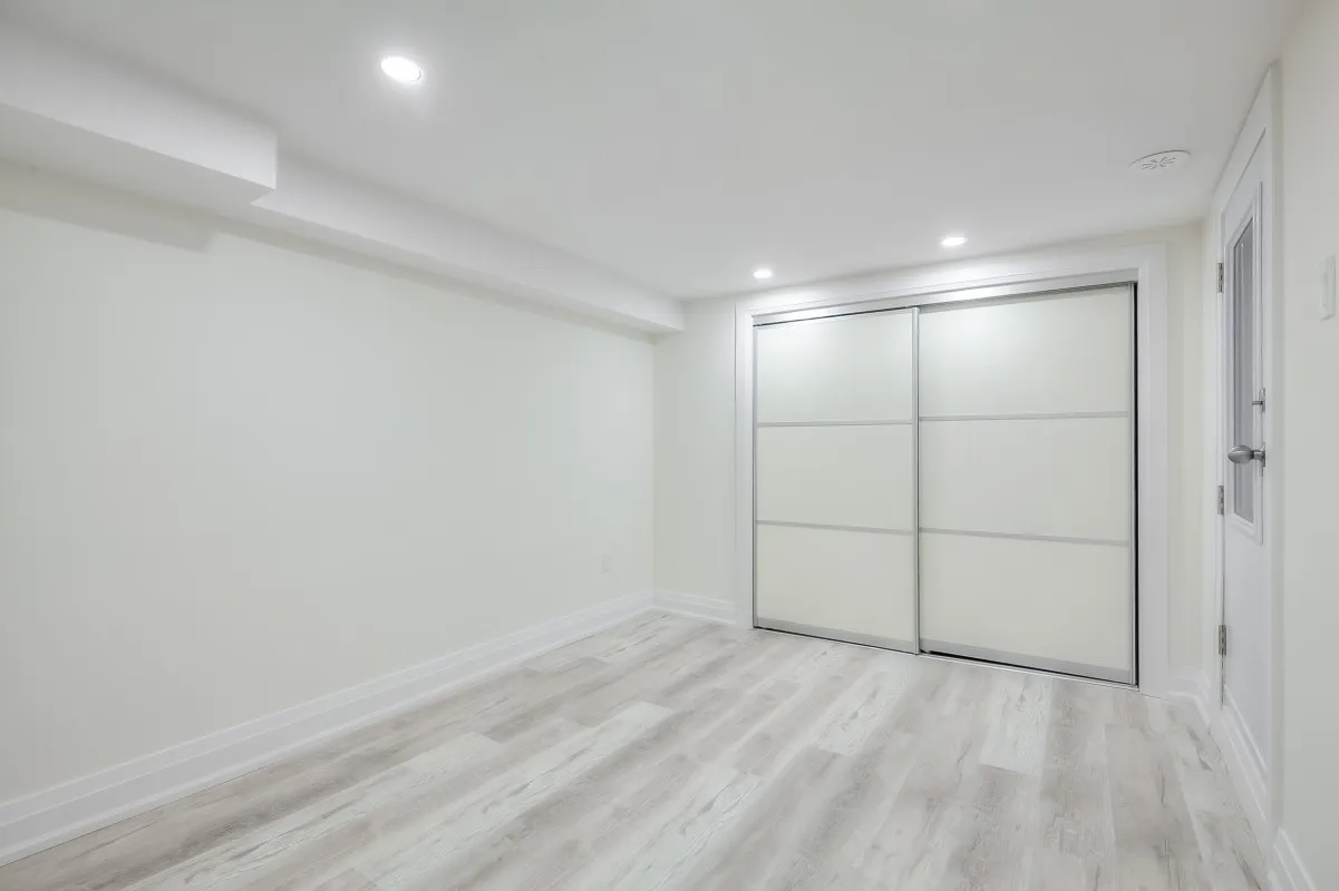 A room with white walls and a sliding door