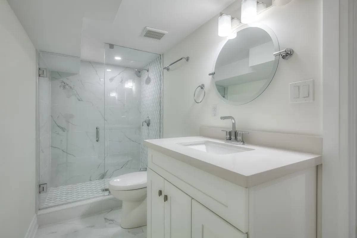 A bathroom with a mirror and a shower