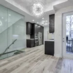 A kitchen and dining room with glass doors