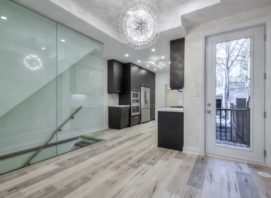 A kitchen and dining room with glass doors