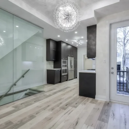 A kitchen and dining room with glass doors