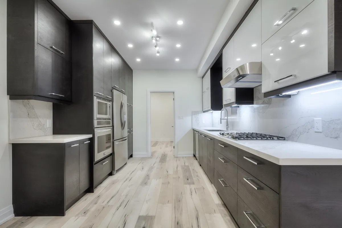 A kitchen with black cabinets and white appliances