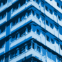 abstract illustration of the side of an apartment building with a blue overlay