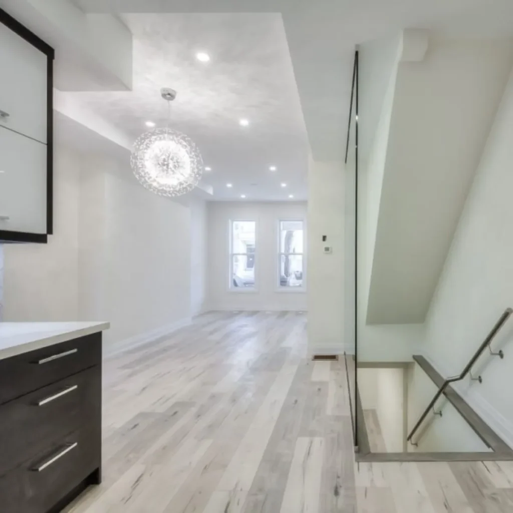 A room with a staircase and a kitchen