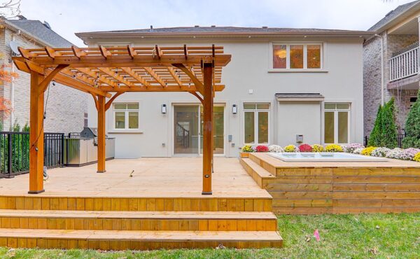 A wooden deck with a hot tub in the back LandLord Property Management