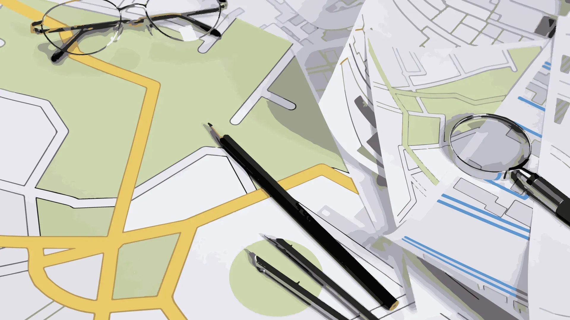 Maps and a magnifying glass on a desk