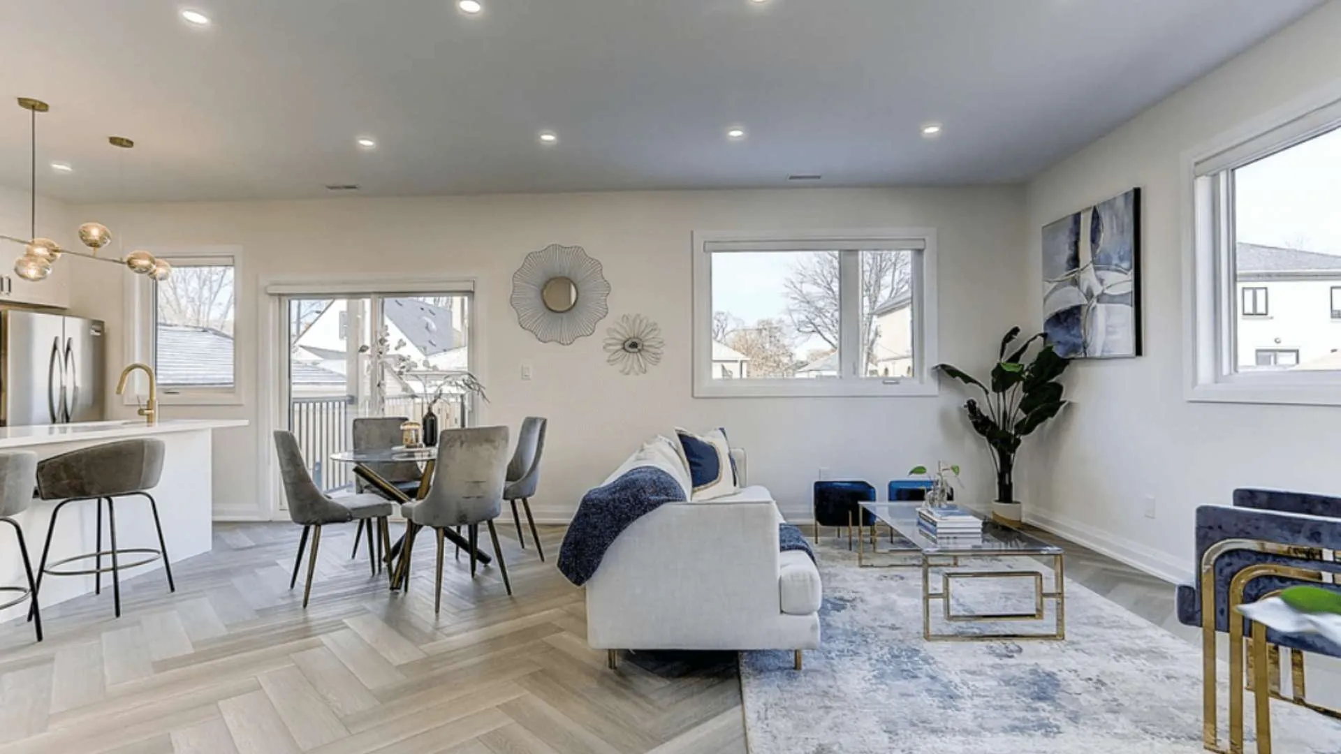 A staged living room with a table, couch and chairs