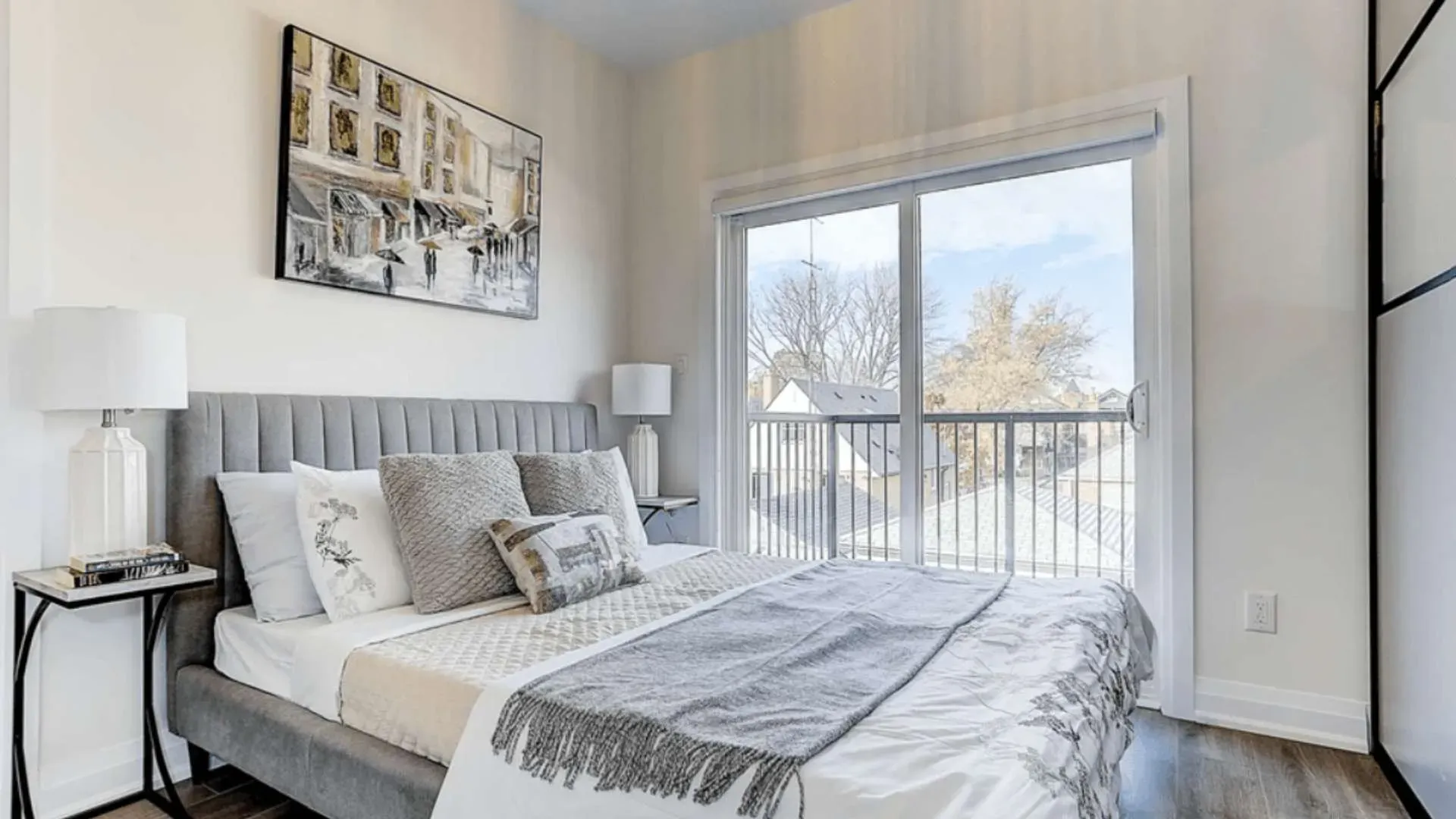 A staged bedroom with big glass window