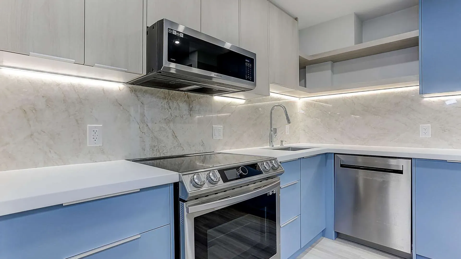 a full renovated kitchen with blue appliances