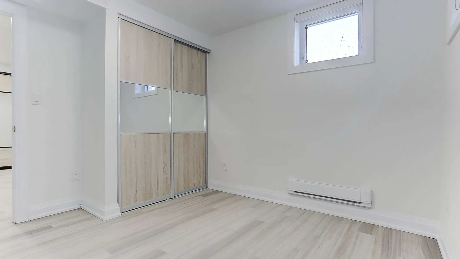 A white bedroom with a built-in closet