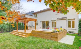 A rental property with a hot tub and a wooden deck