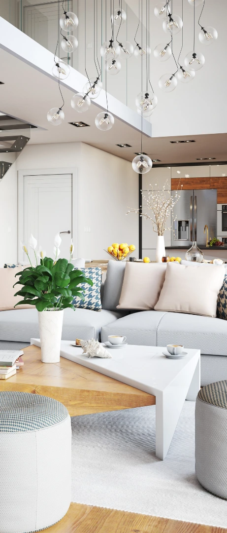 Modern living room with white sofa, coffee table, and decorative plants.